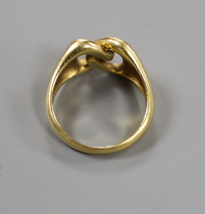 A 750 yellow metal interwoven ring, size O, 7.9 grams.